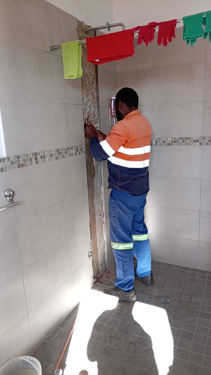 Plumber installing new shower pipework